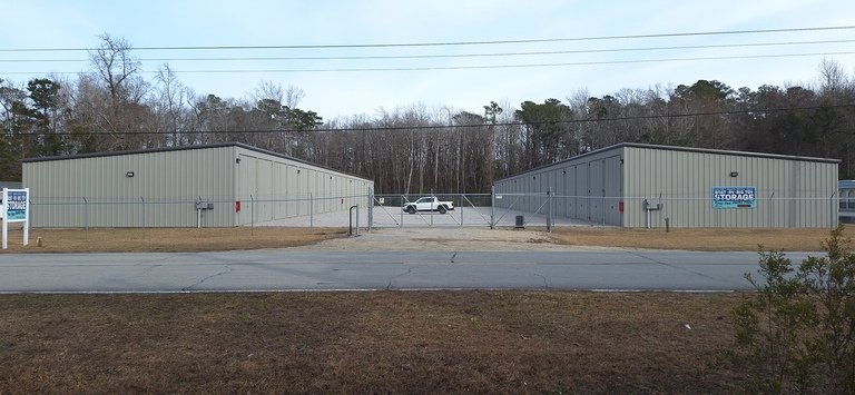 Facility daytime from across the street with truck gate closed